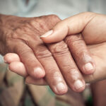 Elderly Fall prevention- Senior and young holding hands
