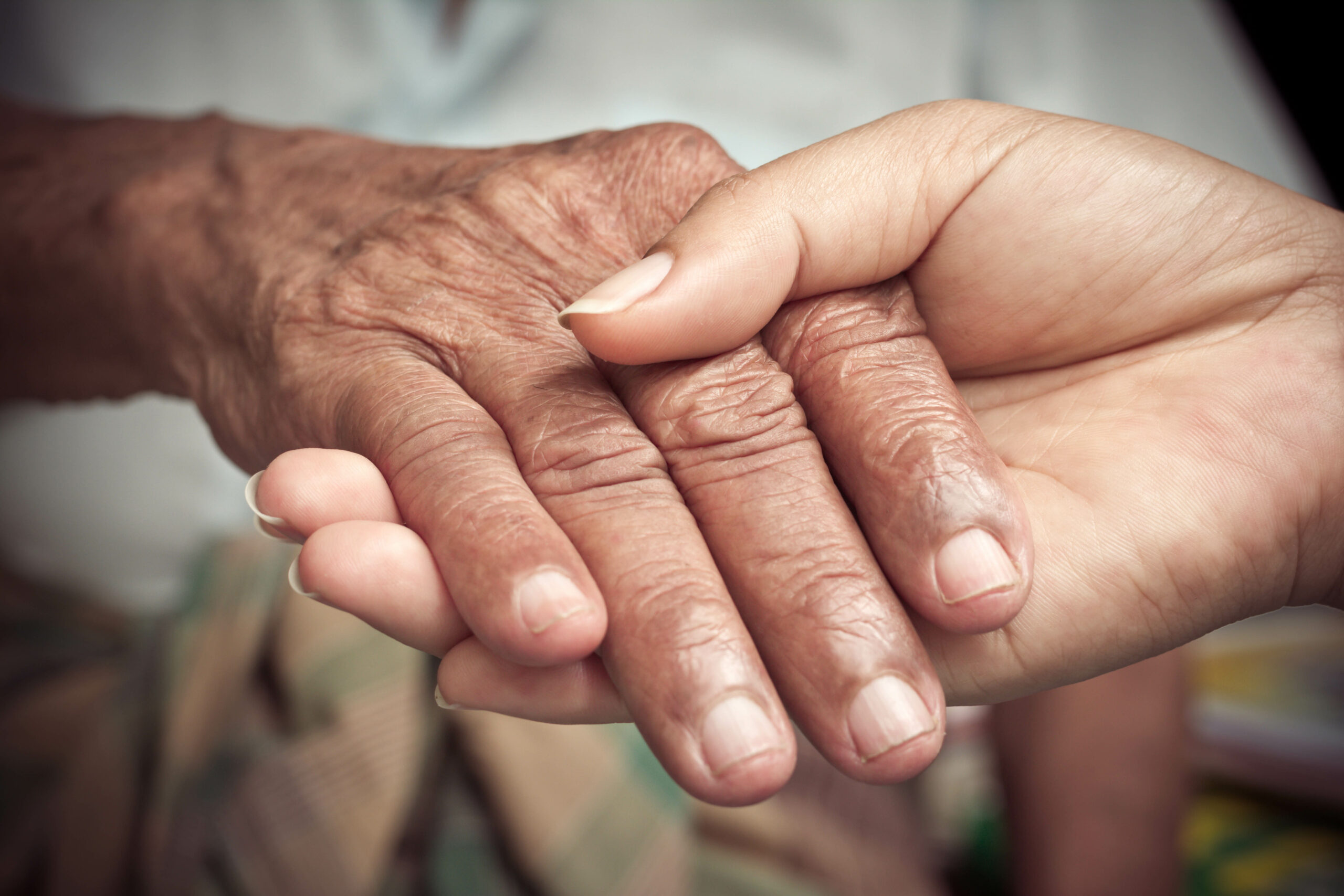Elderly Fall prevention- Senior and young holding hands