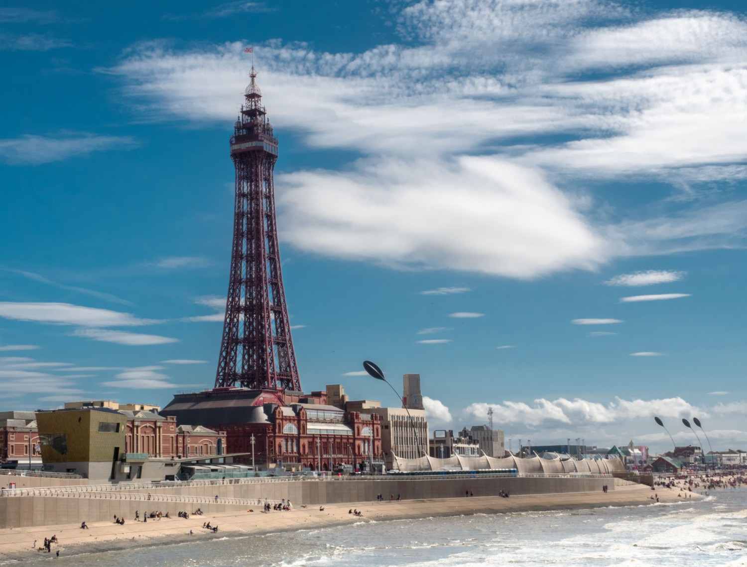 The Blackpool Tower stands tall against a clear blue sky in Blackpool, England, showcasing its iconic architectural design.