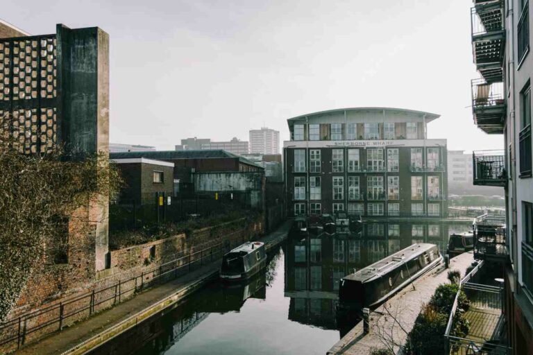 Canals and narrowboats at Sherborne Wharf in Birmingham, with residential buildings and misty morning light.
