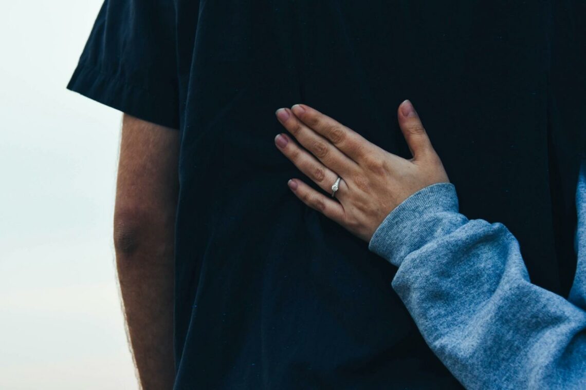 A man and woman are holding hands, symbolizing connection and companionship.