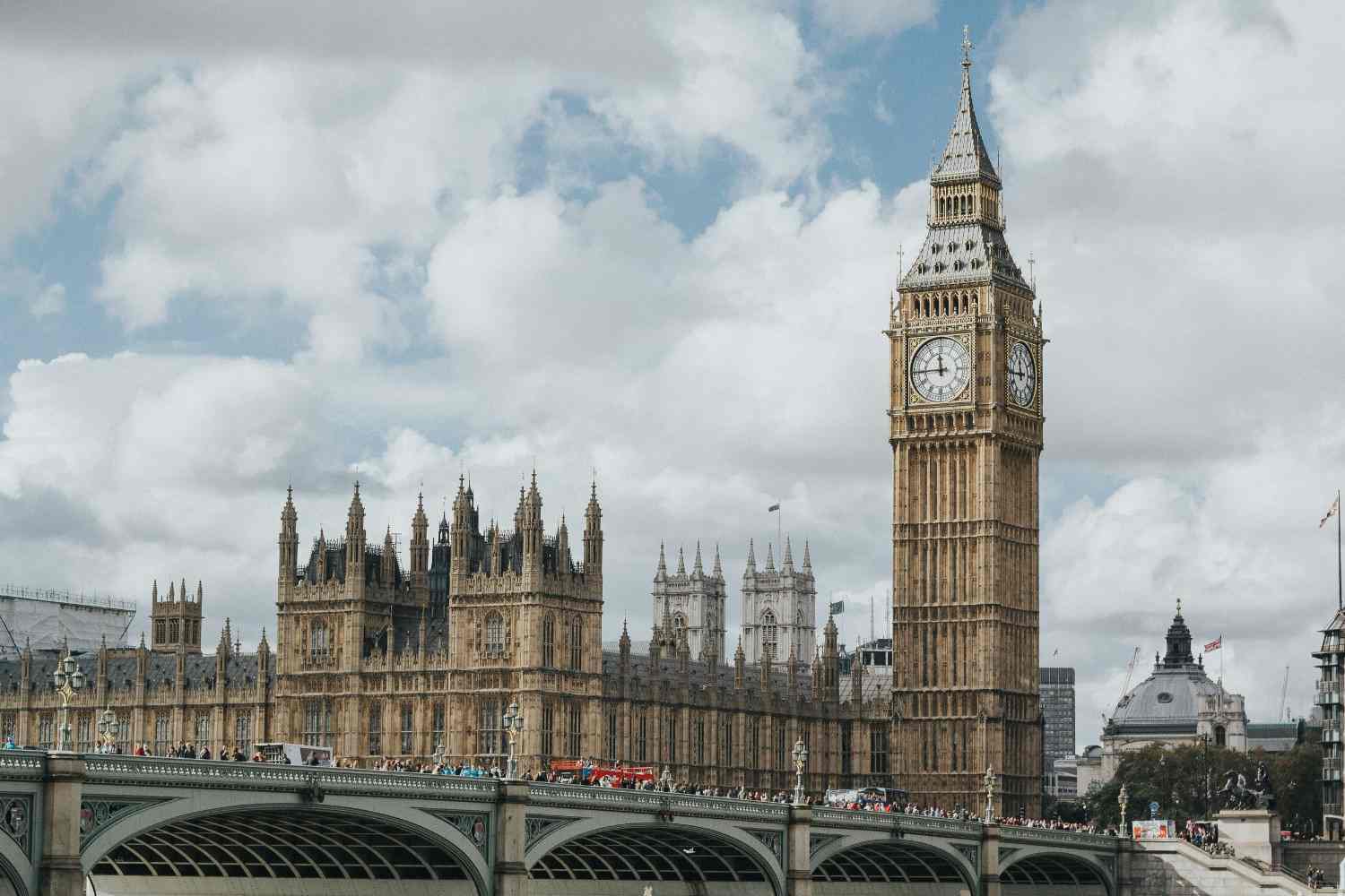 The famous Big Ben clock tower in London, featuring intricate details and a prominent clock face, surrounded by historic buildings.