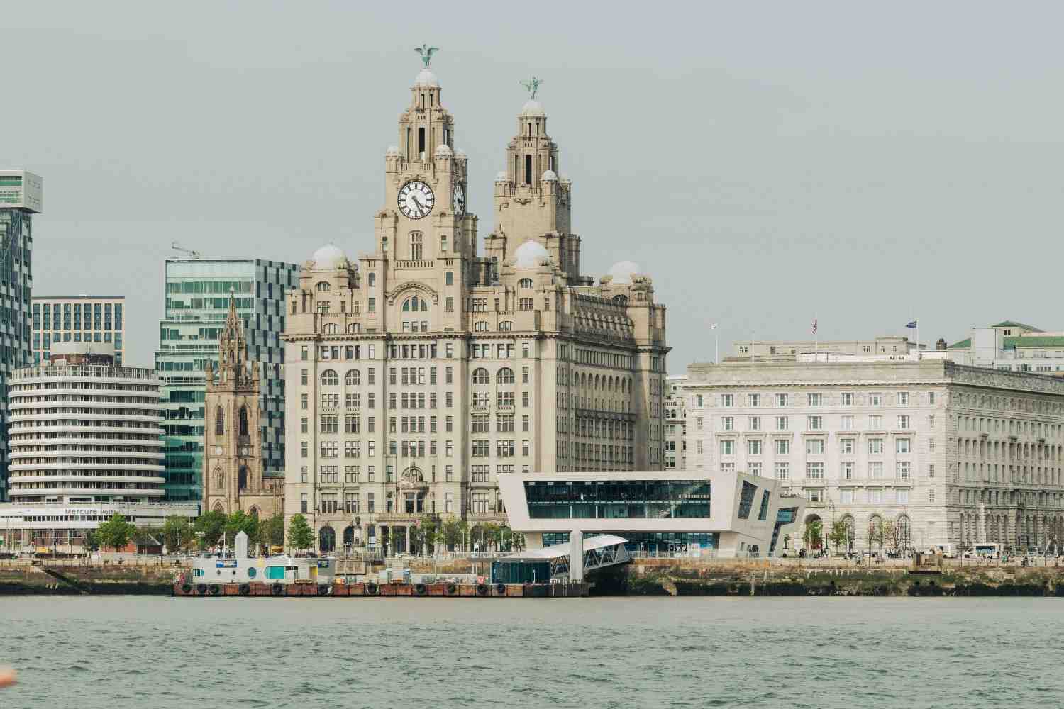 The iconic Liver Building in Liverpool, featuring its distinctive clock tower and two liver bird statues atop.
